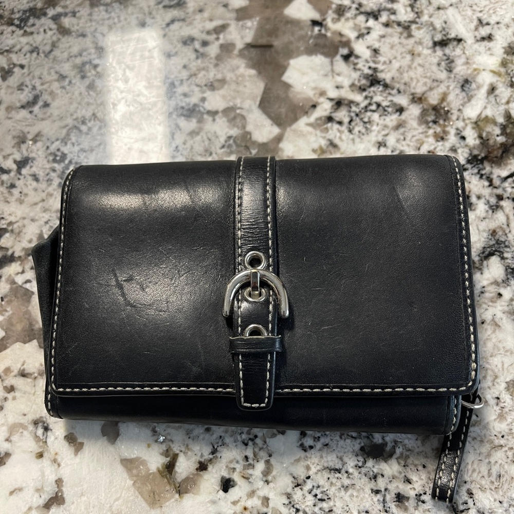 Woman’s Authentic COACH black wallet.